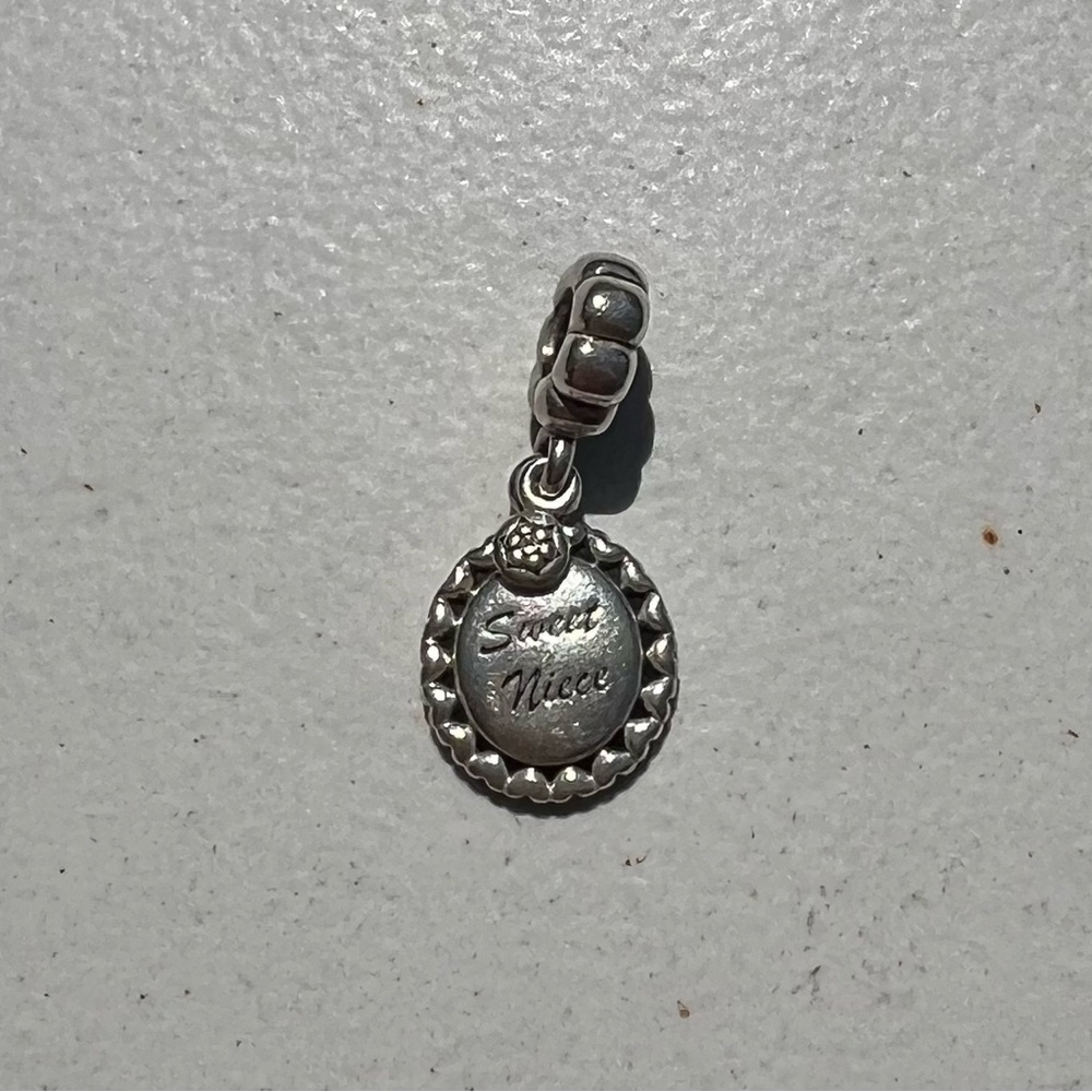 Authentic Retired Pandora “Sweet Niece” charm.
